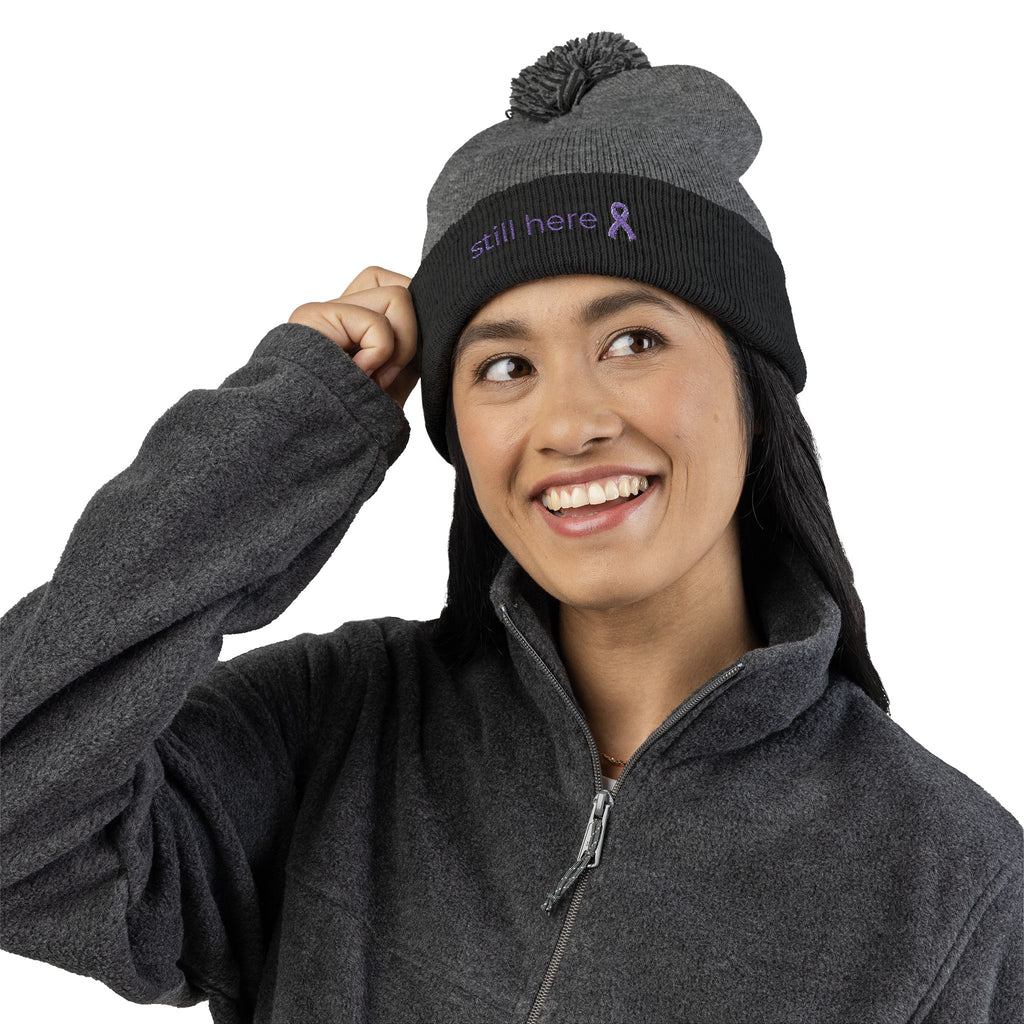 Still Here Pom-Pom Beanie – Epilepsy Awareness Knit Hat with Purple Ribbon