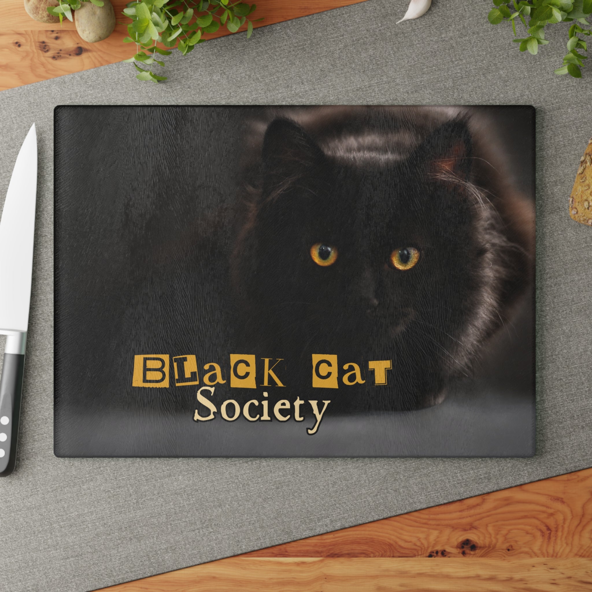 Photo depicting the ​Black Cat Society Glass Cutting Board from EpiAl's Shop.