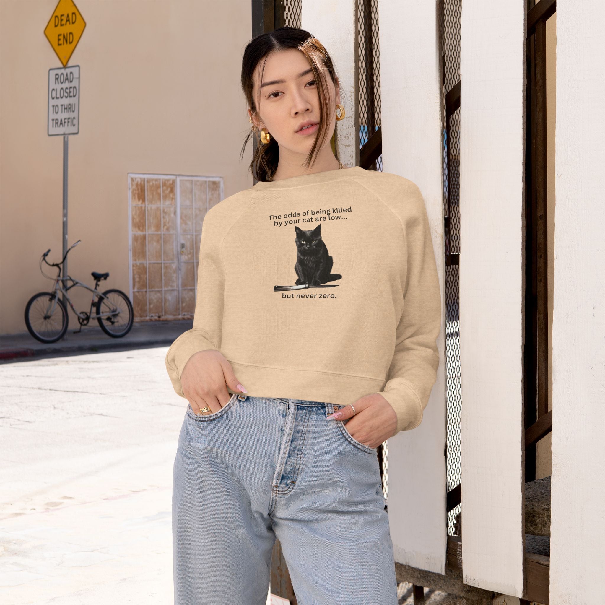 Photo depicting the ​Odds Your Cat's a Killer Women's Cropped Fleece Pullover from EpiAl's Shop.