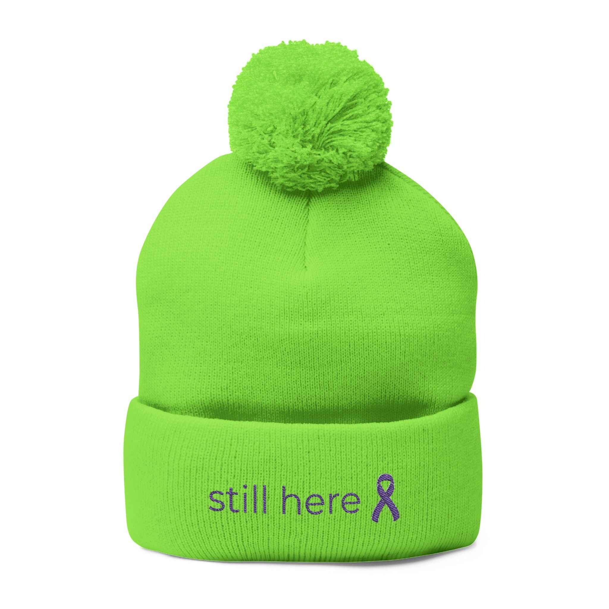 Still Here Pom-Pom Beanie – Epilepsy Awareness Knit Hat with Purple Ribbon