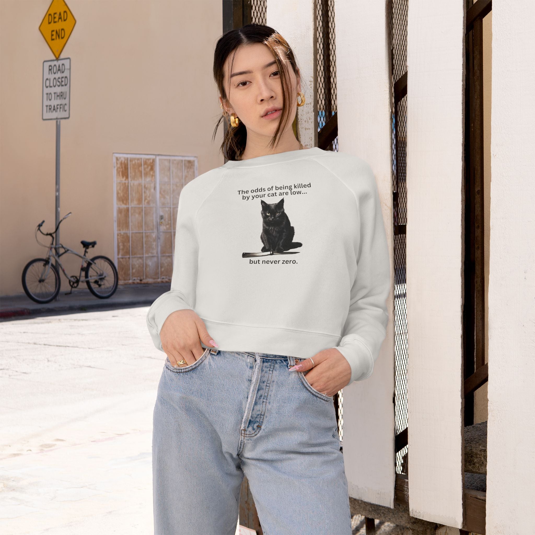 Photo depicting the ​Odds Your Cat's a Killer Women's Cropped Fleece Pullover from EpiAl's Shop.