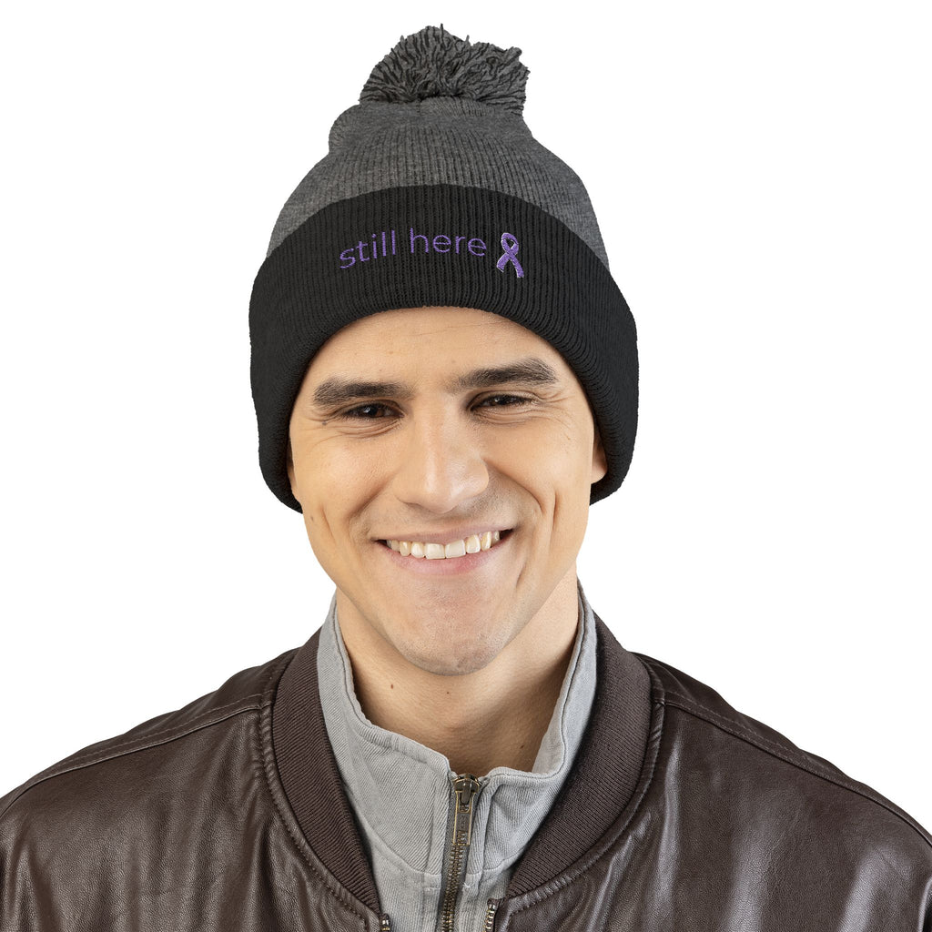 Still Here Pom-Pom Beanie – Epilepsy Awareness Knit Hat with Purple Ribbon