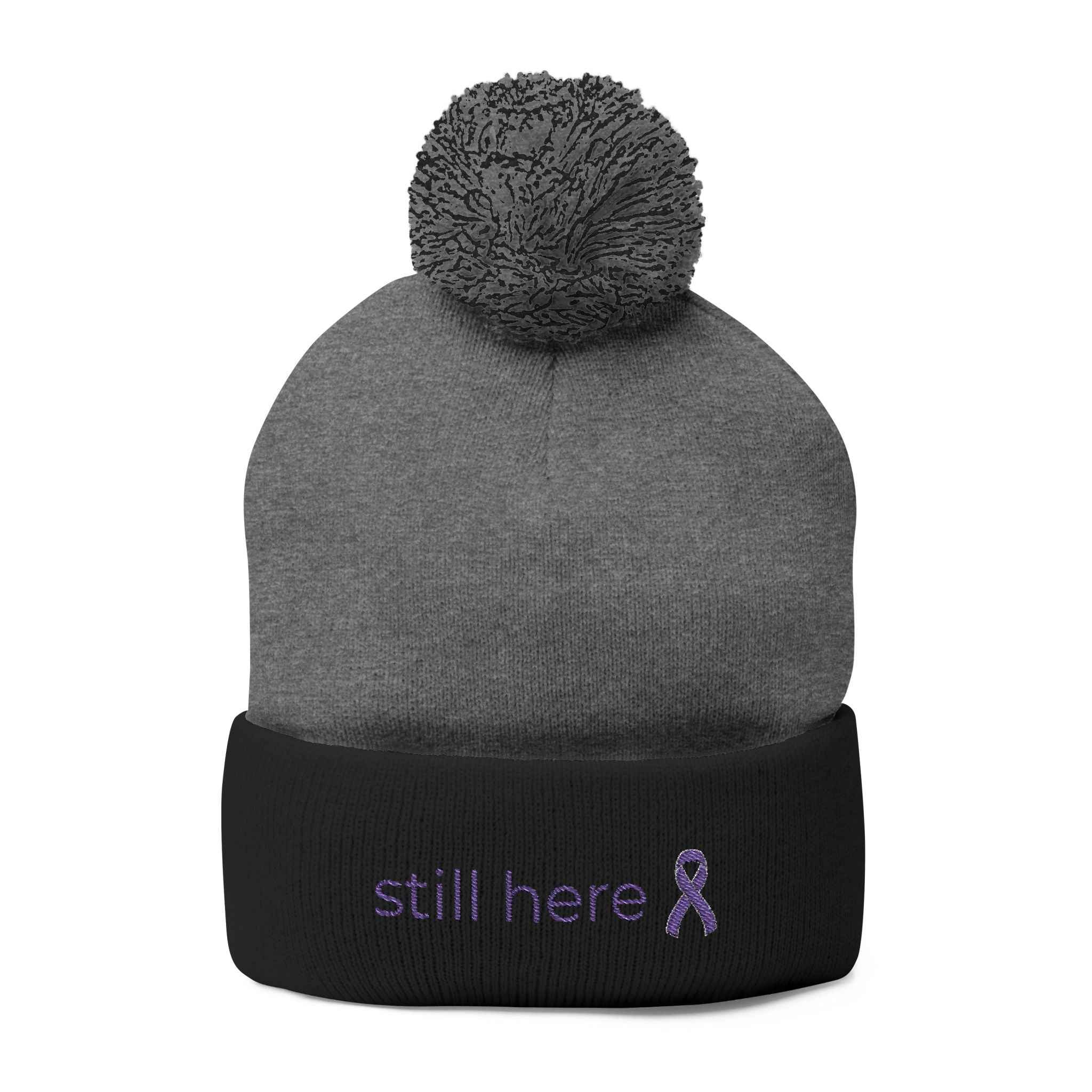 Still Here Pom-Pom Beanie – Epilepsy Awareness Knit Hat with Purple Ribbon