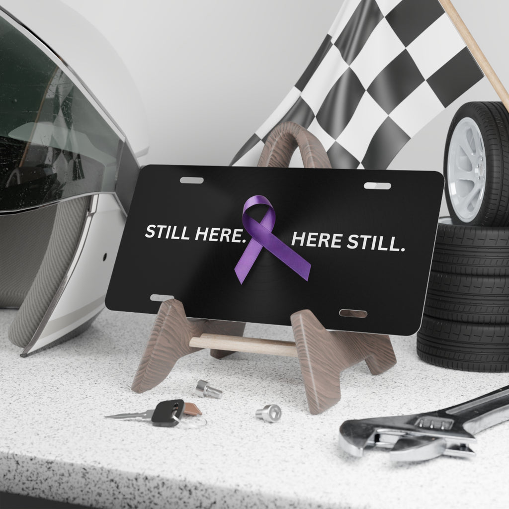 “Still Here. Here Still.” Epilepsy Awareness Vanity Plate – Purple Ribbon