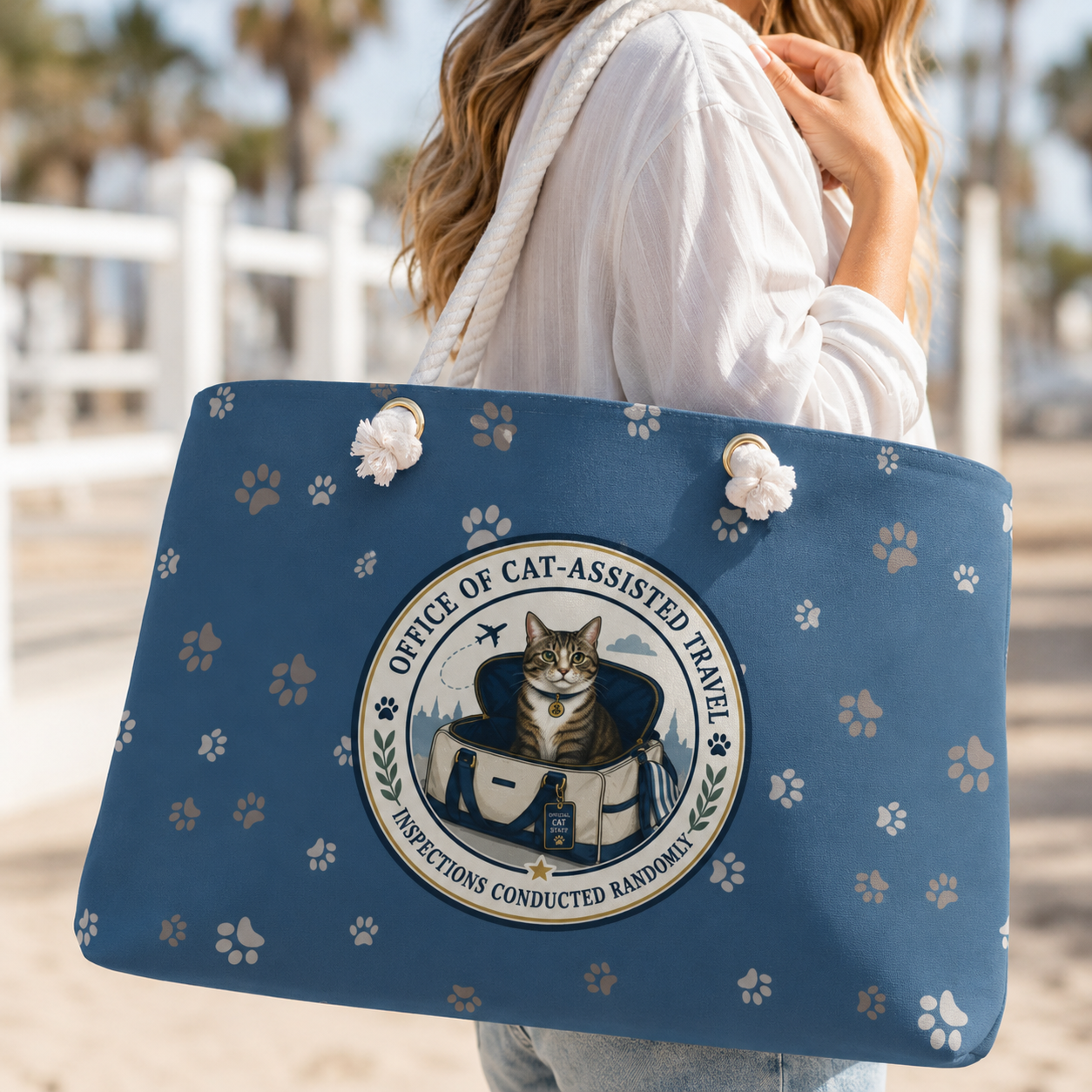 blue cat themed weekender bag on a woman's shoulder