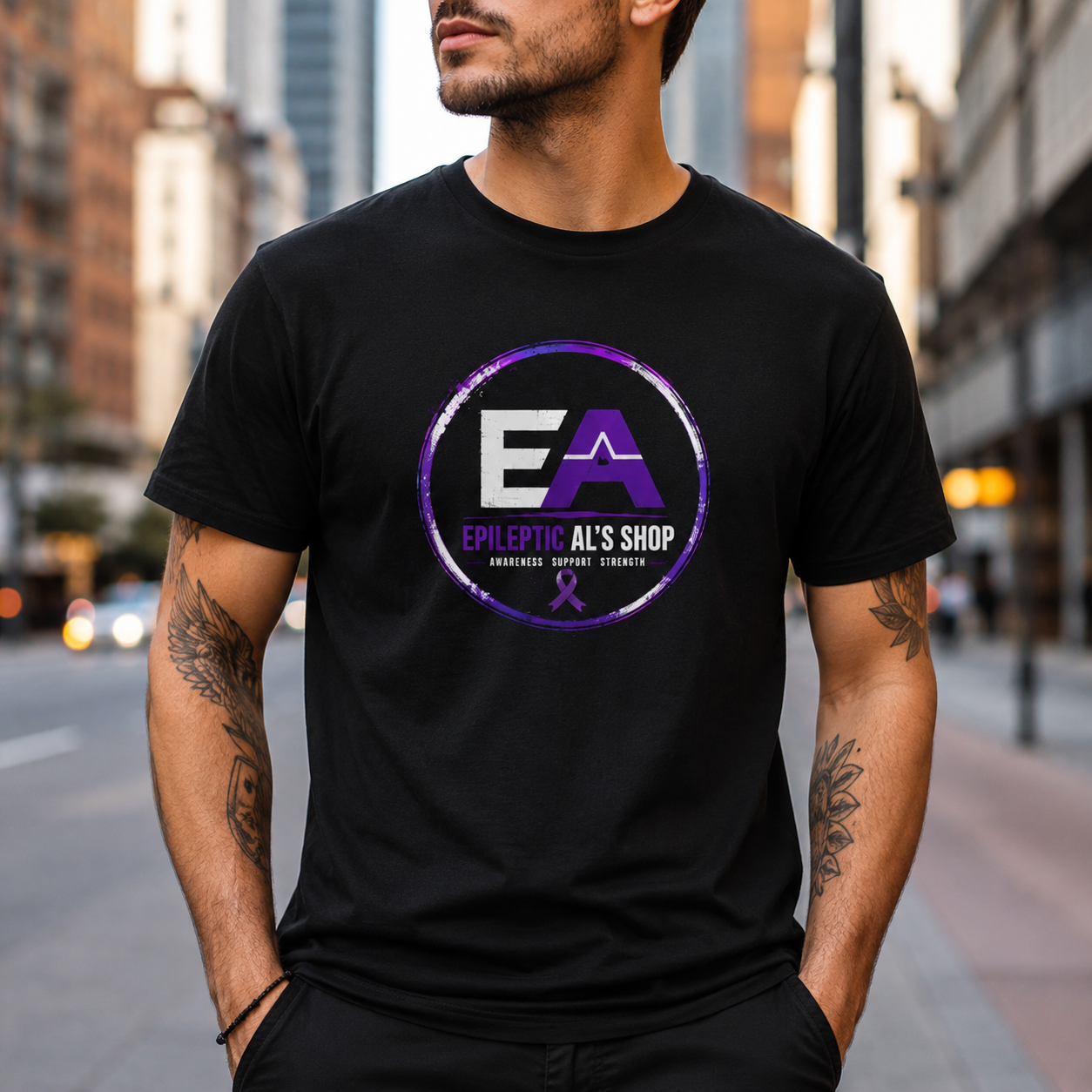 man standing in a city street wearing a black t-shirt